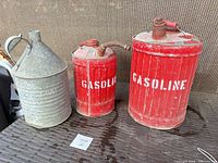 Group view of three vintage metal fuel cans