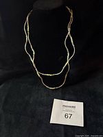 Necklace displayed on bust showing layered appearance