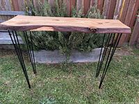 Full view of cedar live edge table on hairpin legs outdoors