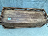 Top view of cedar blanket chest showing distressed brown finish and scalloped gallery rail