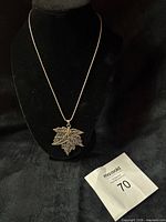 Pendant on chain displayed on bust