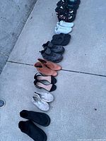 Full lineup of all seven shoe pairs on concrete