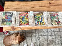 All four Marvel canvas prints laid out on wood table