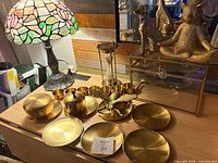 Full lot showing saucers, cups, sugar bowl, bee sculpture, display box, hourglass, cat and dog figurines