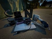 All items group shot outdoors: steamer, scale, flat iron, letters, case, cables