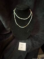 Necklace doubled on bust form