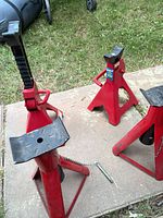 Two ratchet and two fixed jack stands on patio