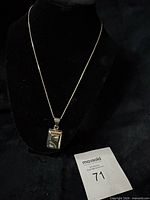 Full view of pendant necklace on display stand