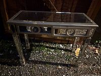 Front view of mirrored console table showing apron and legs