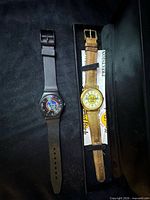 Two Hard Rock Cafe watches in box showing both styles