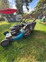 Left side view Yardworks mower showing deck, engine, bag