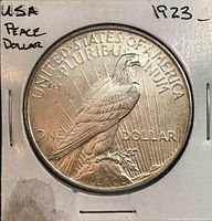 Reverse of 1923 Peace Dollar showing eagle, inscriptions and wear