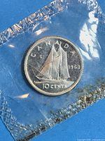 Reverse showing Bluenose schooner design, sealed packaging visible