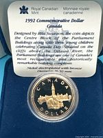 Reverse side of 1992 commemorative dollar inside capsule with certificate text visible