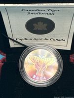 coin in capsule inside clamshell case with certificate behind