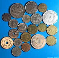 All twenty mixed world coins on blue background