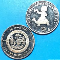 Both 1978 trade dollars obverse sides visible: St. Marys crest coin and Killarney Leprechaun coin