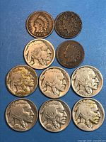 Pyramid arrangement of all 10 coins displaying obverse sides and most readable dates