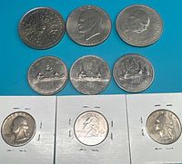 All ten coins laid out on blue background