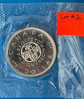 Reverse of 1964 Charlottetown silver dollar in sealed packaging