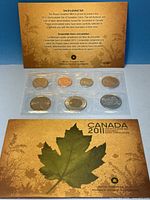 Front view showing COA card, sealed 7-coin strip and outer folder