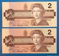 Obverse of both $2 notes showing Queen Elizabeth II, serials cropped