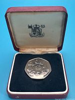 Coin in open Royal Mint presentation box
