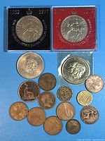 Overview of all coins including two packaged 1977 crowns, 1972 crown, 1981 crown, and assorted smaller coins