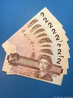 Obverse side of eight Canadian $2 bills fanned out