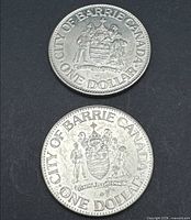 Two coins obverse with coat of arms and ONE DOLLAR legend