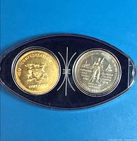 Both tokens in plastic display case