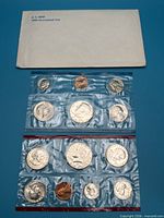Overall lot showing U.S. Mint envelope and both sealed 1980 coin pouches
