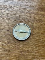 Reverse of 1967 Centennial 10-cent coin with mackerel, denomination and dual date