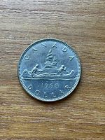 Reverse of the coin showing Voyageur canoe design and date 1968