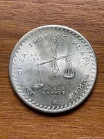 Obverse showing scales, legends, silver surface