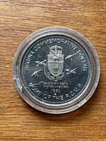Obverse of coin showing coat of arms and inscriptions