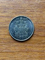 Reverse side showing Canadian Coat of Arms, denomination and commemorative dates