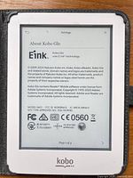 Front of Kobo Glo in case showing About screen, model and certification details