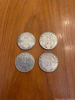 Four Newfoundland 50 cent coins reverse side showing denomination and years 1917 and 1919