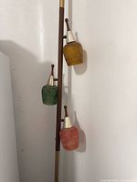 Full view of tension pole lamp with three colourful shades