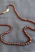 Full view of cherry amber bead necklace