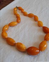 Full view of amber bead necklace laid flat