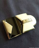 Top view of black and ivory Lucite belt buckle showing clasp detail
