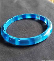 Top view of the light blue lucite bangle bracelet showing color and faceted design