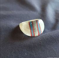Oblique view showing red, blue and glitter stripes in translucent lucite dome
