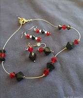 Necklace with both earring pairs displayed