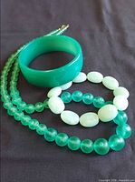 Group shot showing lucite bangle, necklace and bead bracelet