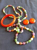 Entire jewellery set with bangle, earrings and necklace displayed