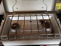 Interior view showing two burners and cooking grate