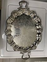 Full view of ornate silver-plated tray with handles